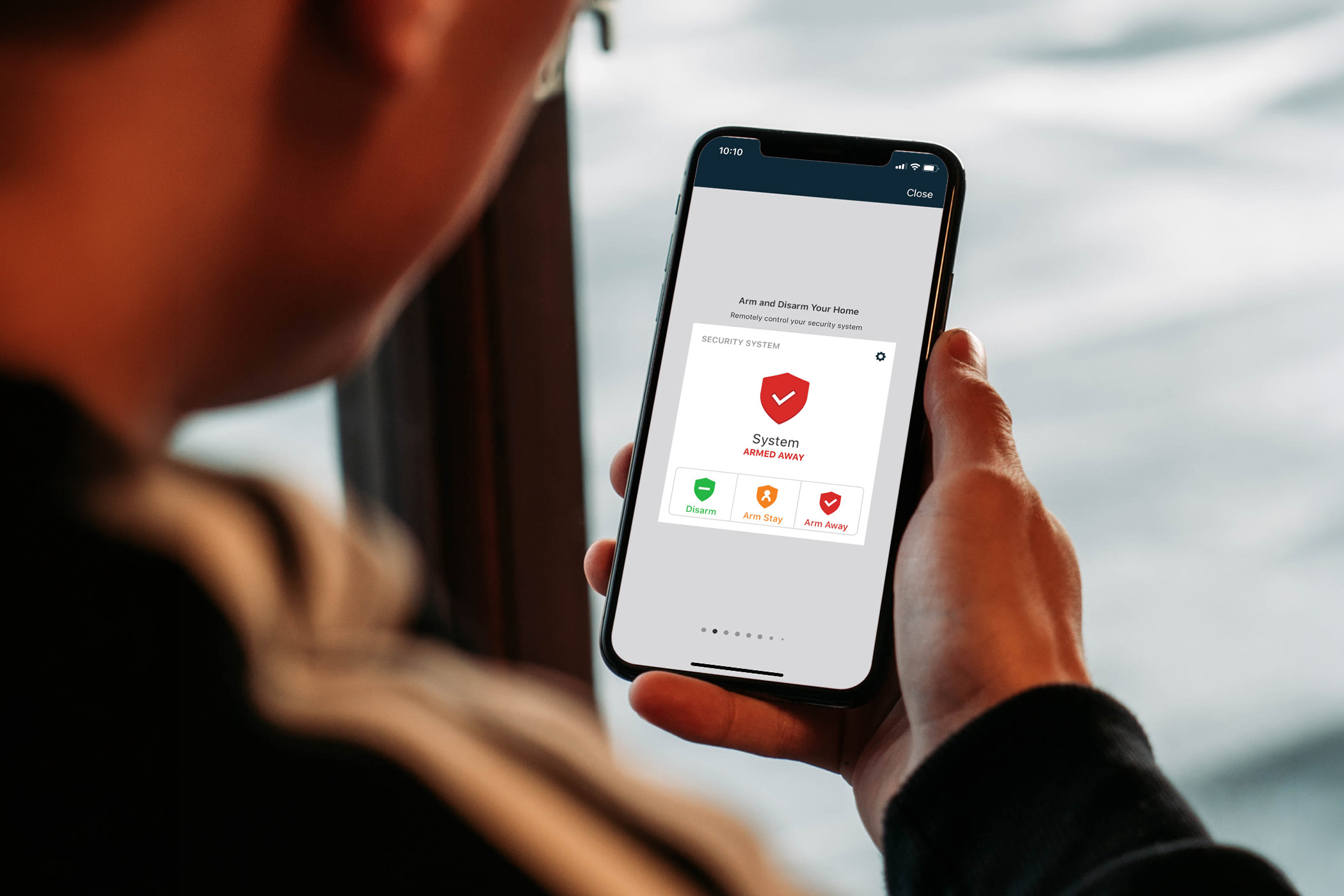 Man checking home security system alert via app. 