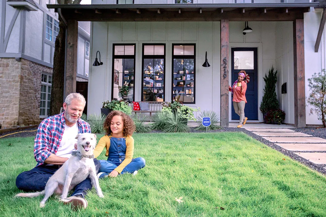 Family enjoying summer outside of house