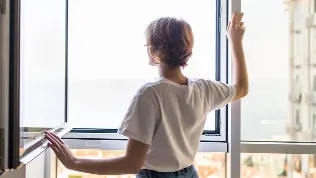 Women staring out the window with sensors.