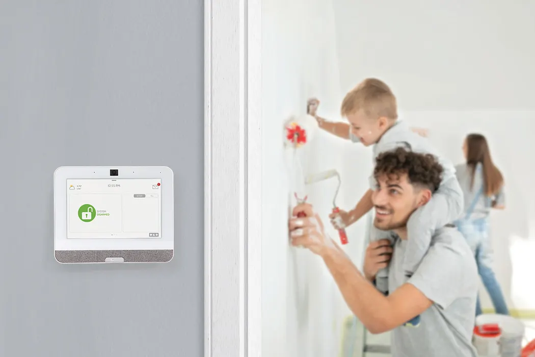 How to disable security cameras blog image containing father and son painting and the IQ4 panel, updated 2024 by Ian S.