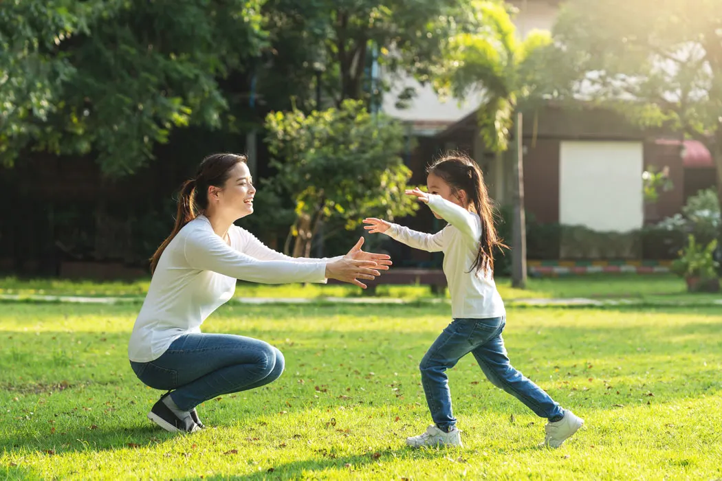 Mother embracing child outdoors