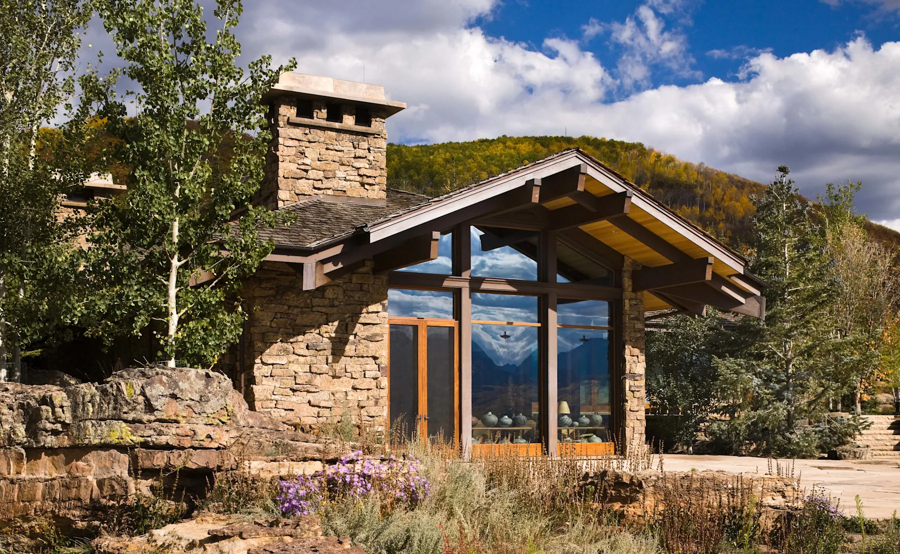A mountain house in the Rockies is composed of stone and stucco. 