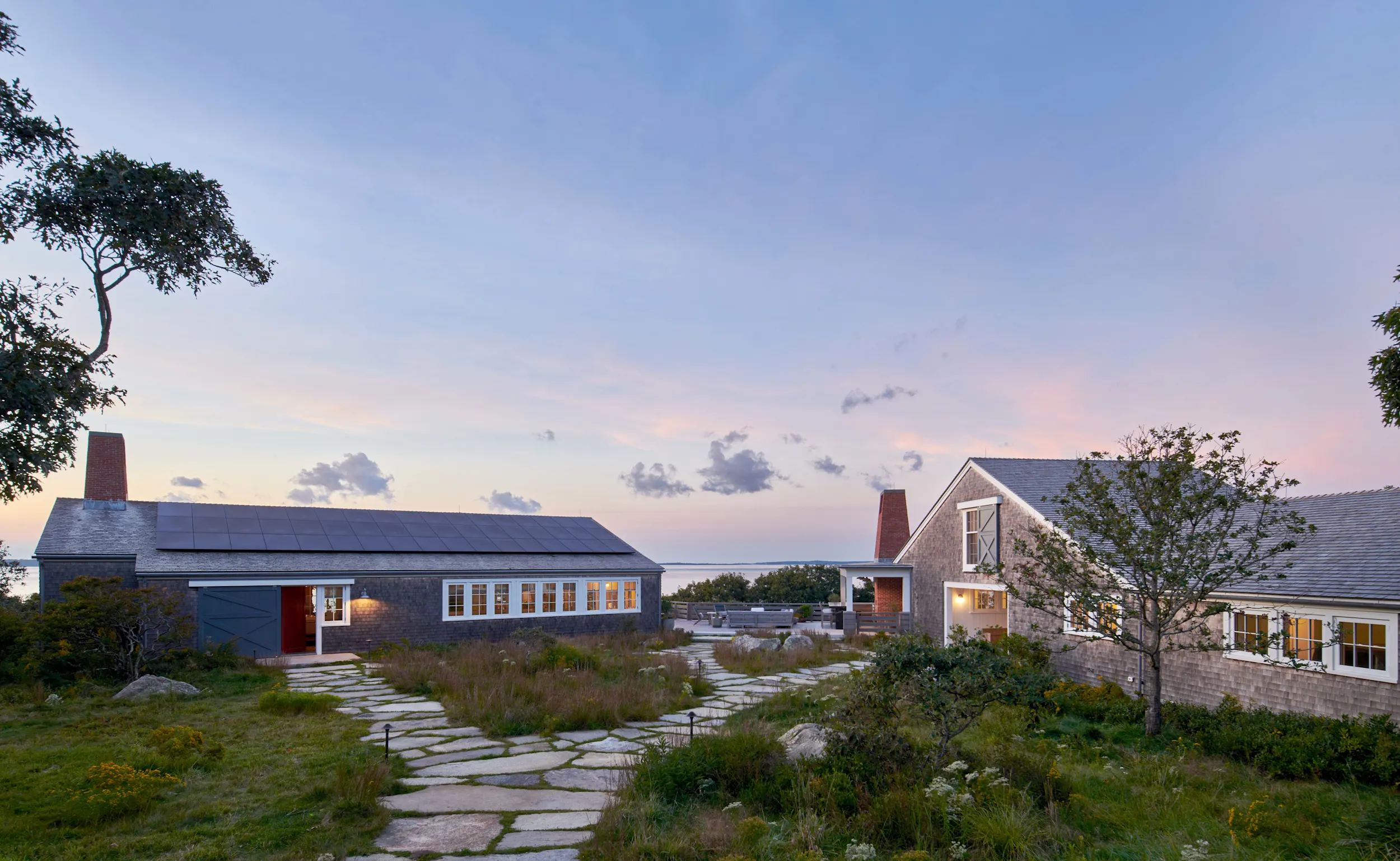 A shingle style guest retreat overlooks the Atlantic Ocean.