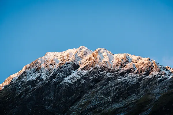 Alpenglow on Snow-Dusted Peaks