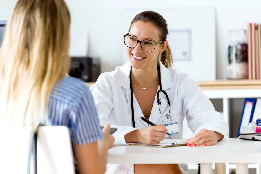 the doctor and the patient are sitting at the table and talking