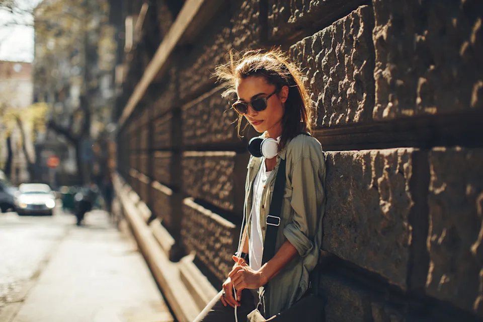 Teenage girl leaning against a wall