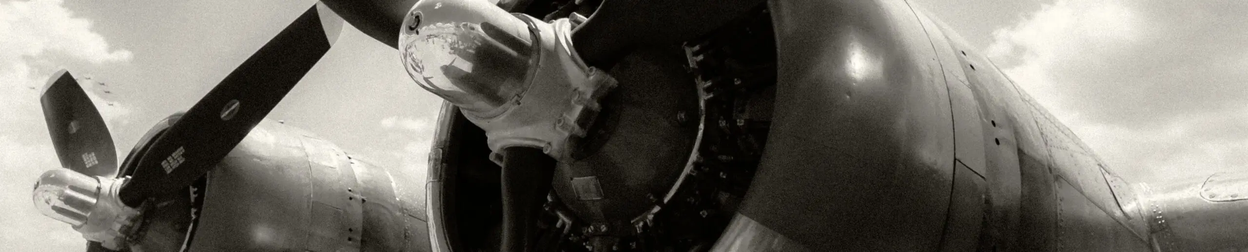 Low angle greyscale shot two propellers plane ready takeoff