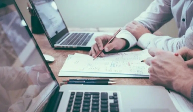 man taking notes during a meeting