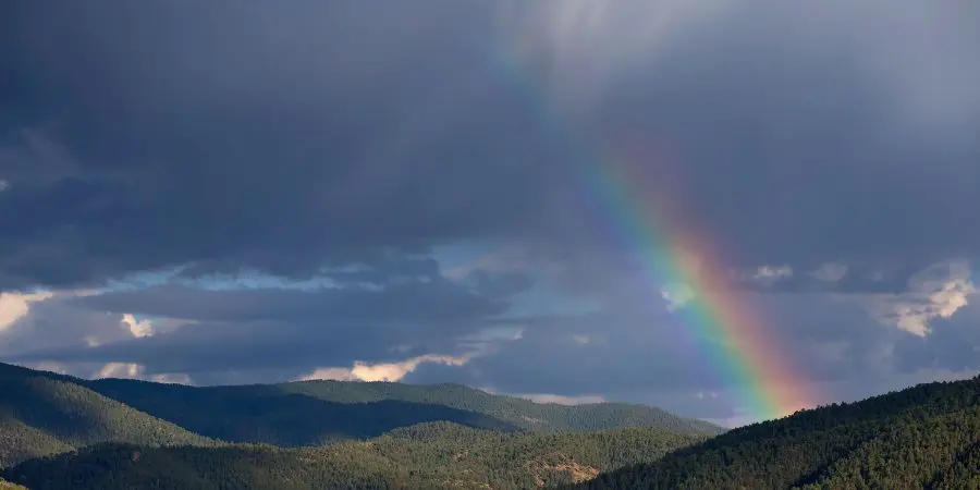 A rainbow over a mountain pass