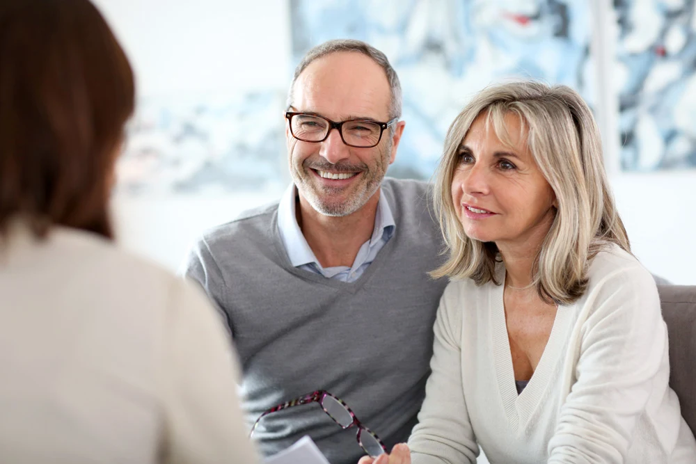 A middle aged couple in a meeting with an advisor