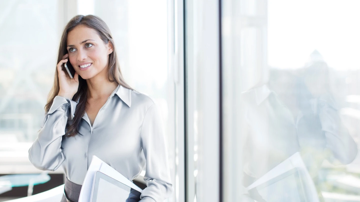 Woman in an office using a mobile phone