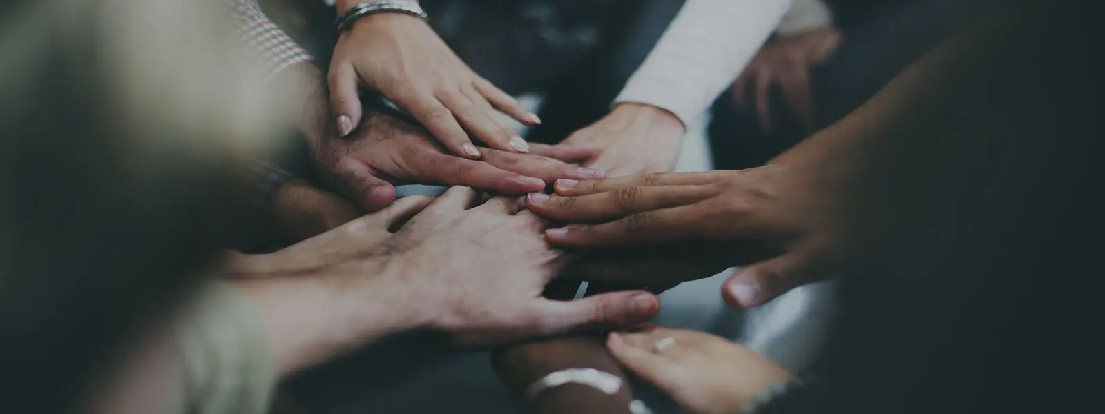 People joining hands showing teamwork