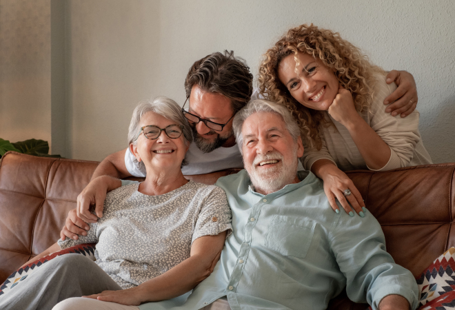 elderly couple smiling with famil members