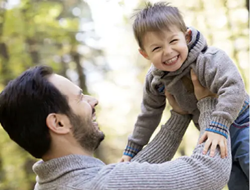 A father holding his son in the air