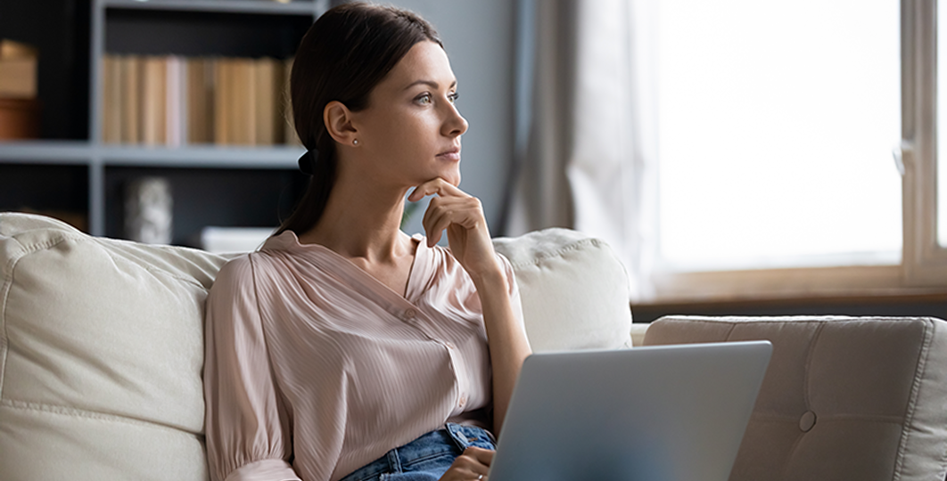 woman reflecting at home with her laptop