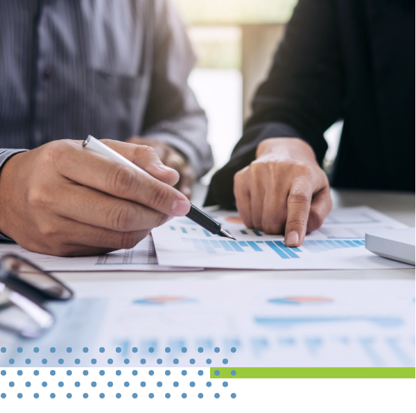 stock image of two people reviewing charts in an office