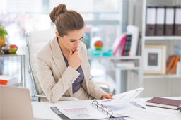 A woman reading papers in a binder