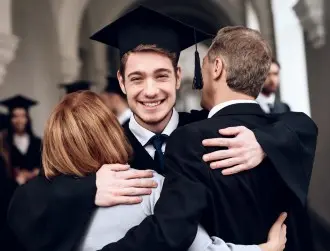 Man graduating and hugging parents