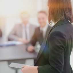 A female presenting in the conference room