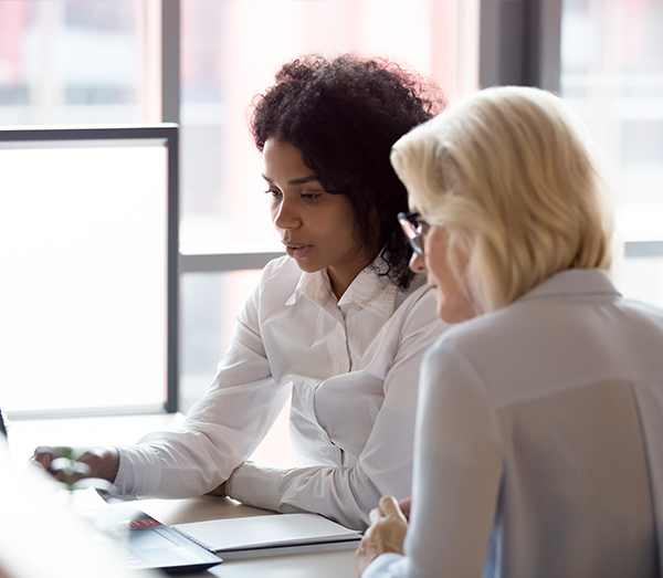 African American female advisor sharing information with her client in a team setting