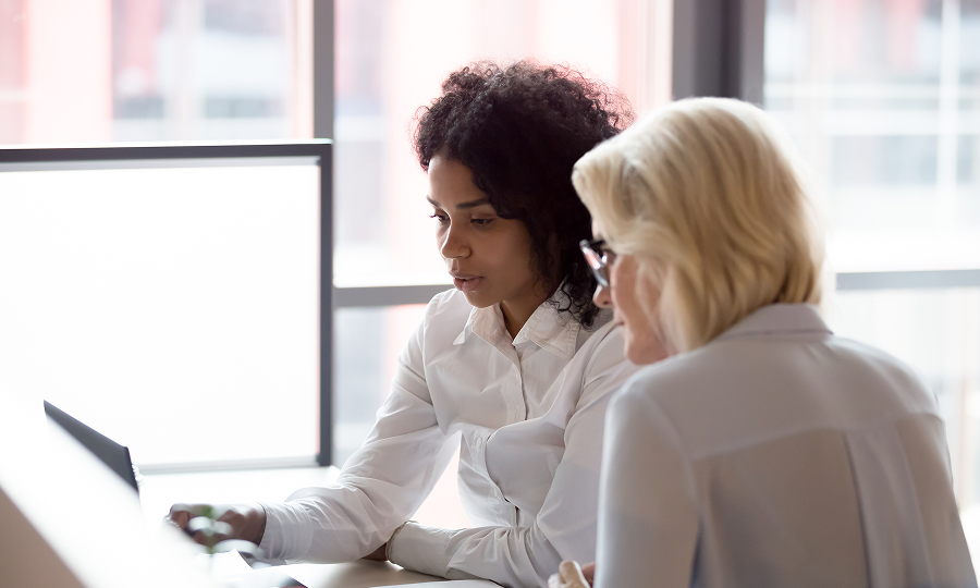 White Pine - Two Women Looking at Laptop