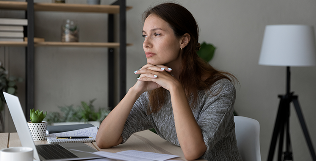 woman pondering estate plans at her desk