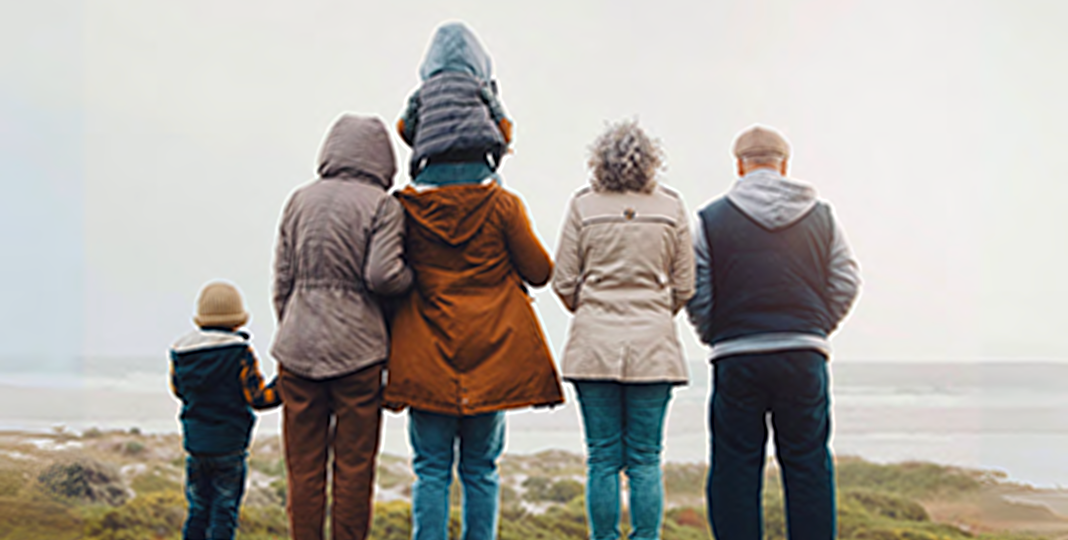 family standing at beach