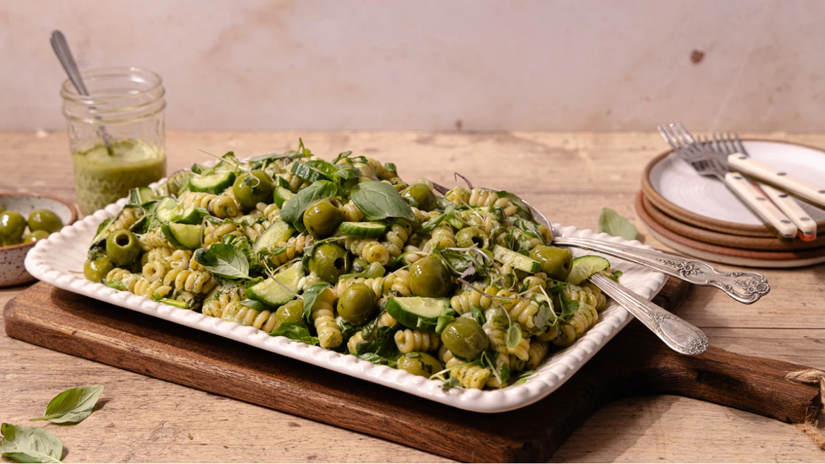Delicious green pasta salad with olives and fresh basil