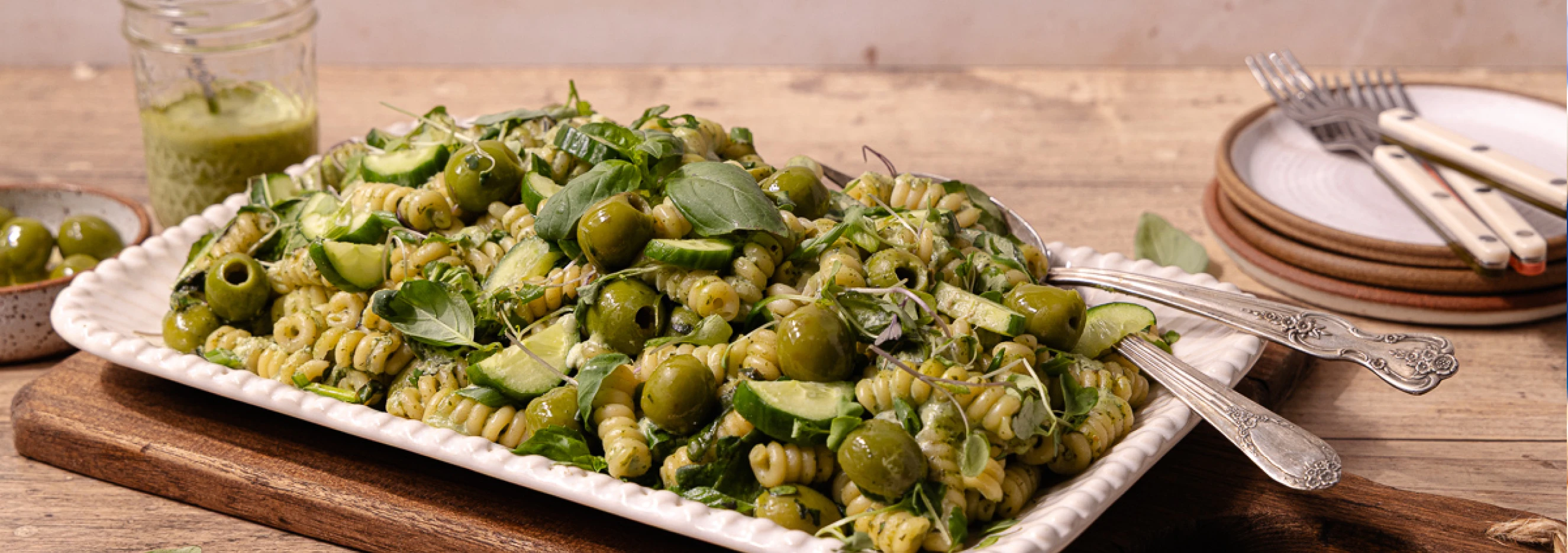 Delicious green pasta salad with olives and fresh basil