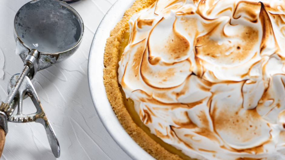 Lemon meringue pie with an ice cream scoop next to it