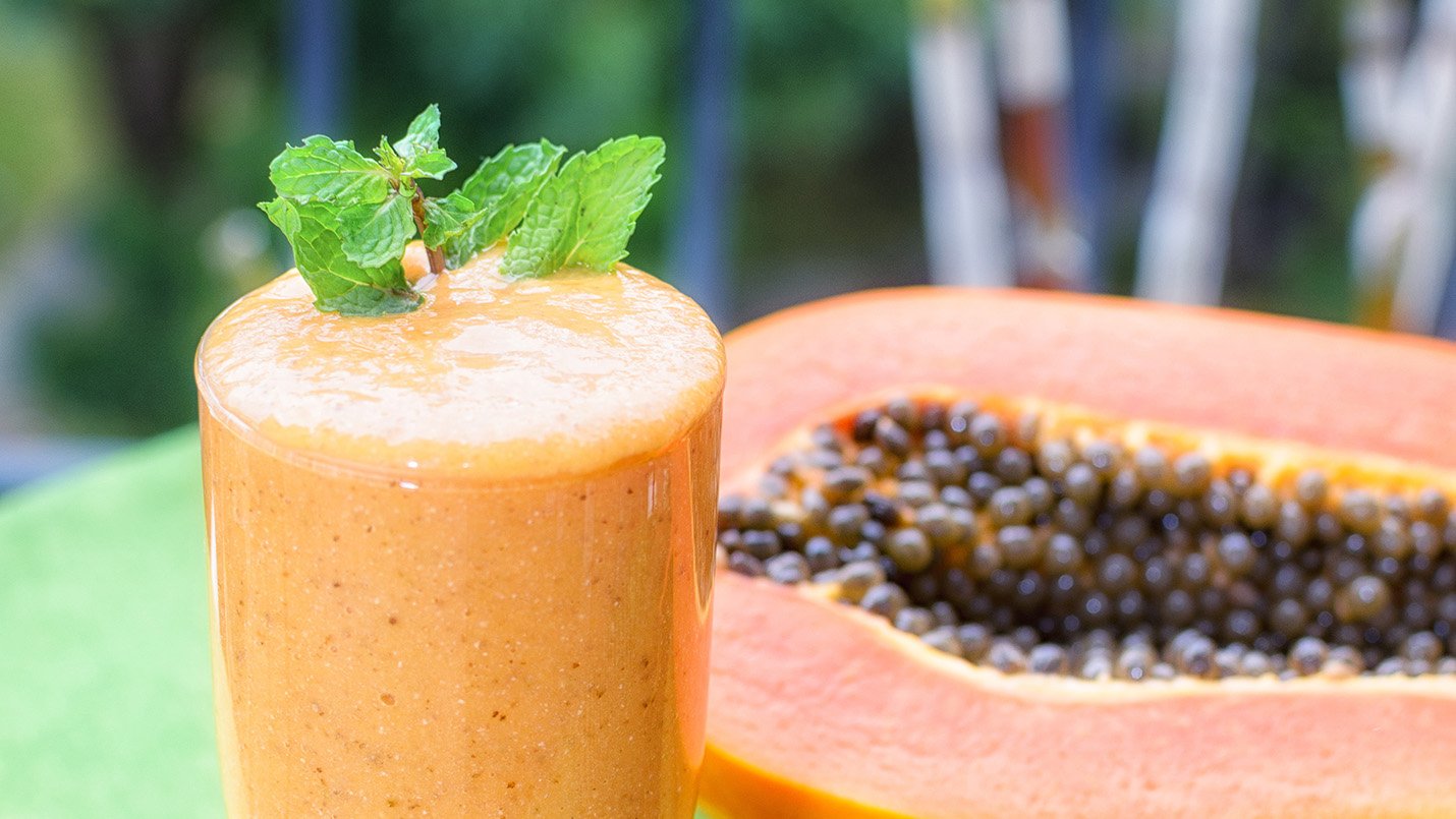 Lactose free papaya shake topped with mint leaves