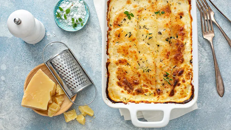 Baked potato dish topped with cheese and thyme