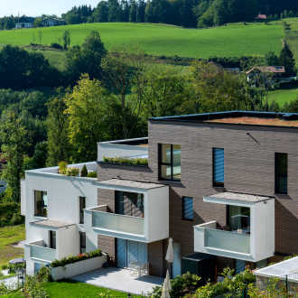 modernes Gebäude mit einem Flachdach von BMI Villas und mehreren Balkonen mit Kiesbestreuung welches sich in einer ländlichen, natürlichen Lage befindet