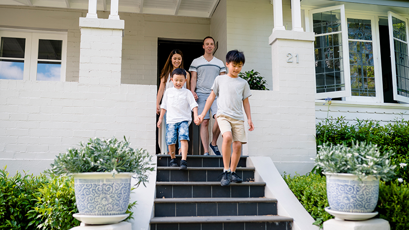 young-family-walking-down-stairs-front-home