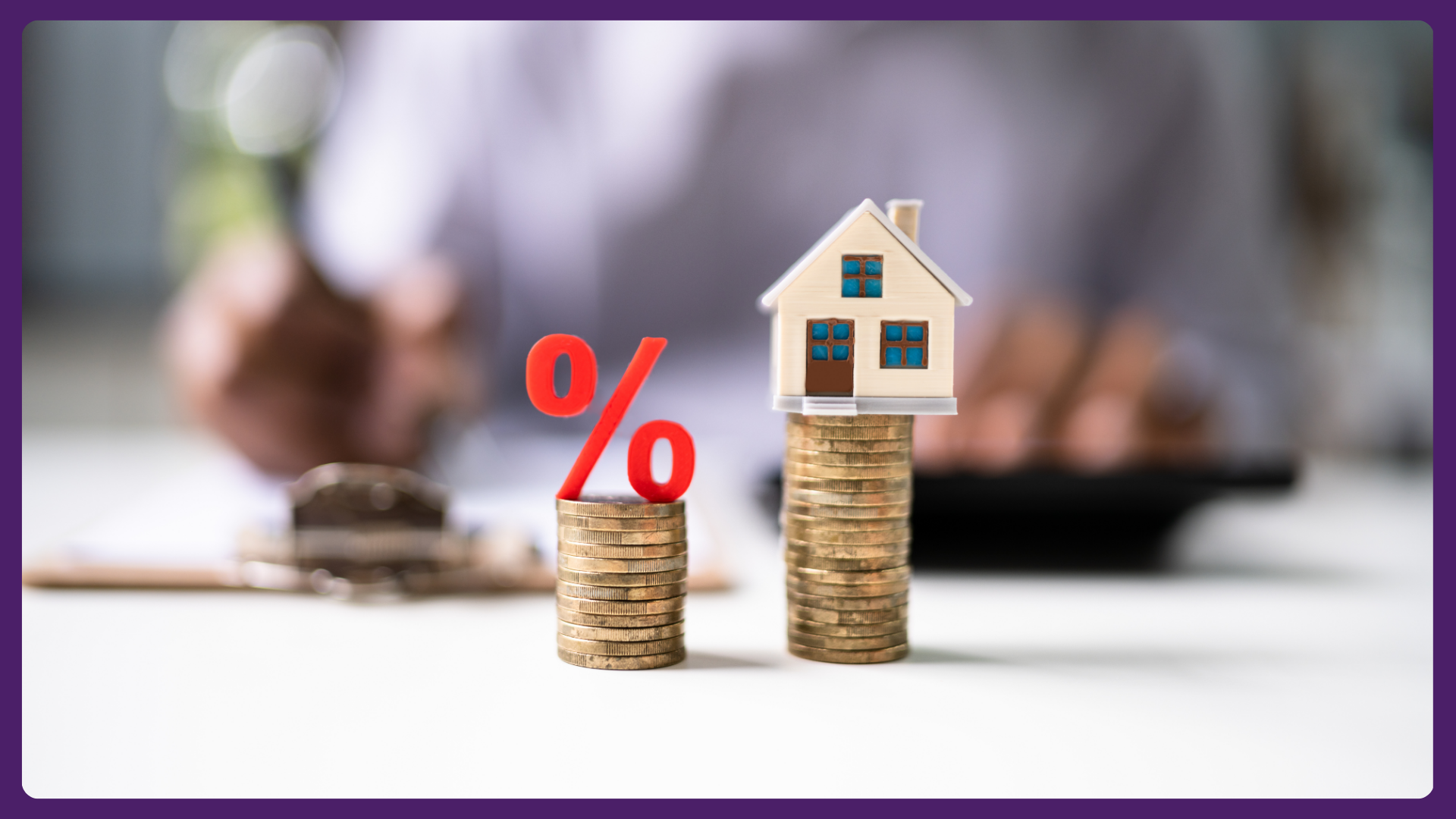 A red percentage symbol and a miniature house sit on separate stacks of coins.