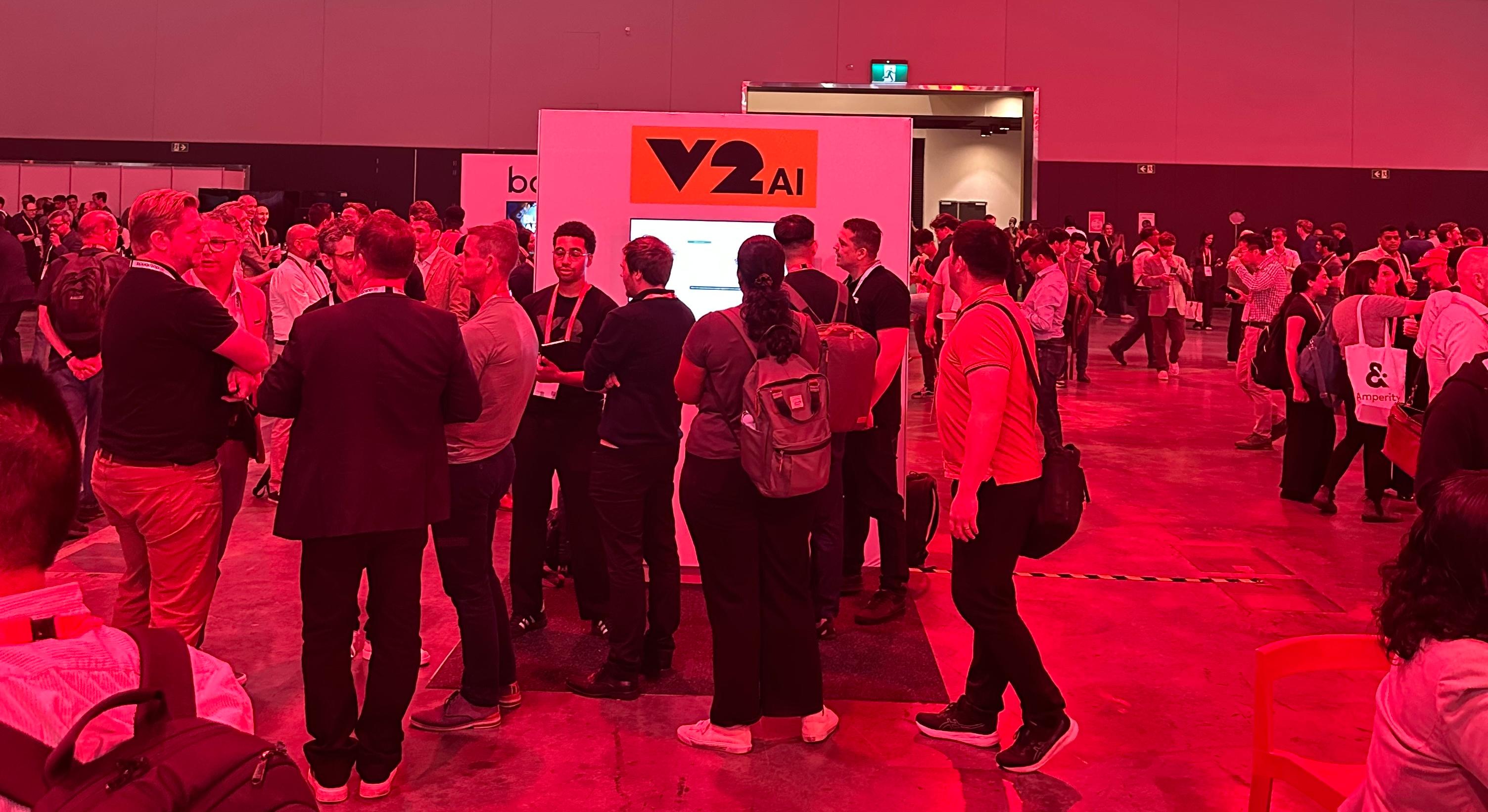 V2 AI's booth at the Databricks World Tour, showcasing agentic AI demos.