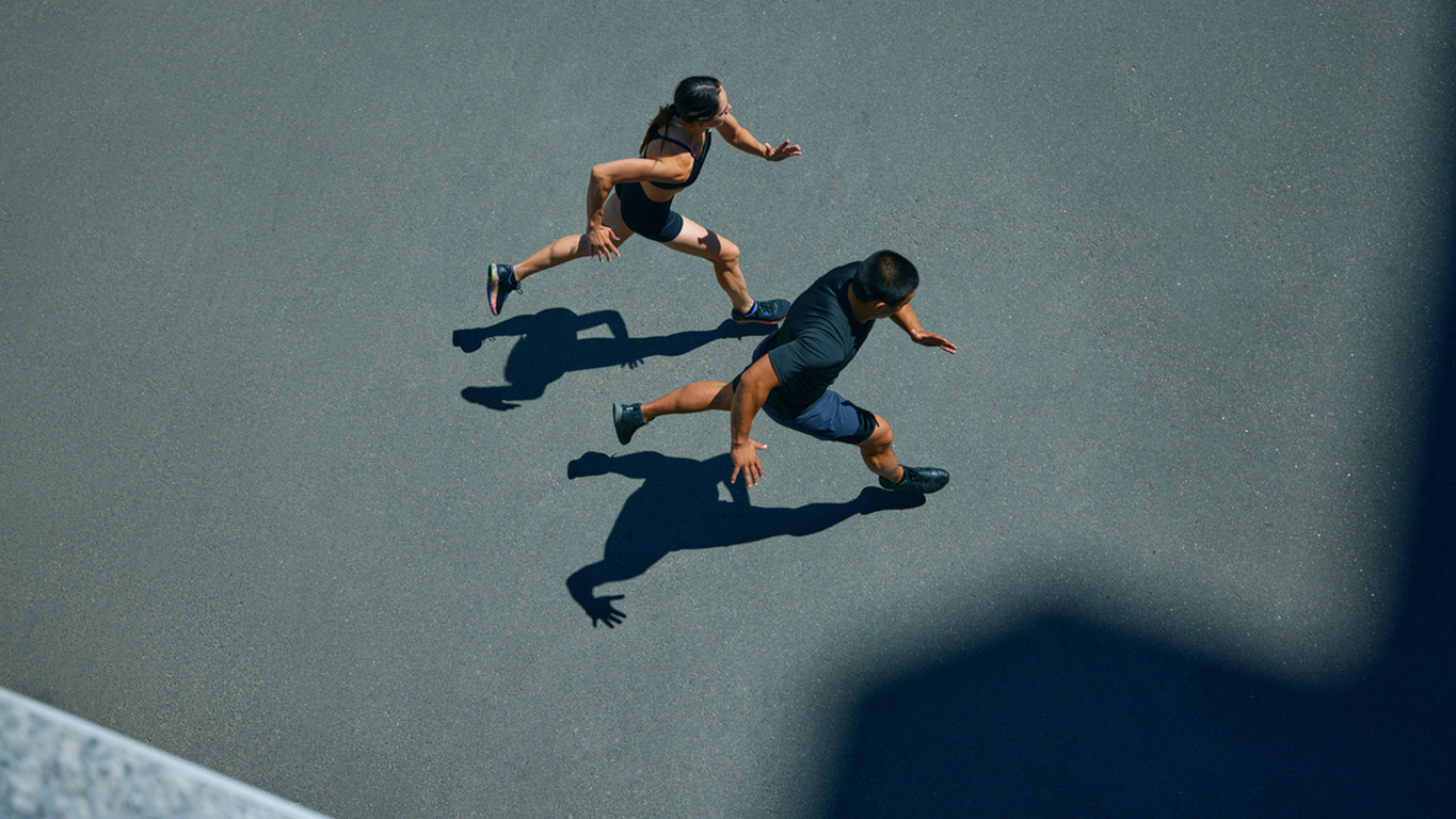 Image showing two people running together indicating Product and Data Engineering alignment for AI project delivery at velocity