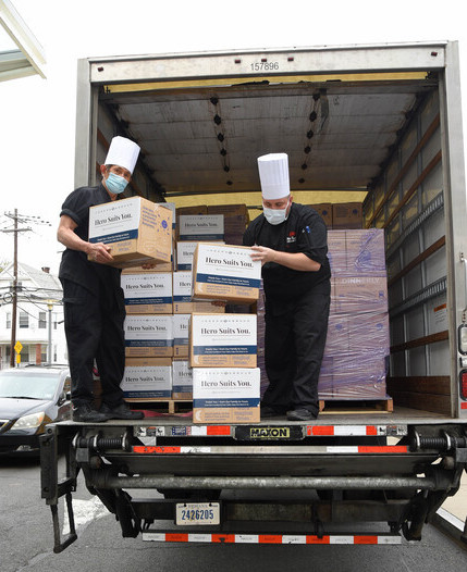 Hospital culinary staff load Dinnerly meal kit boxes onto a truck