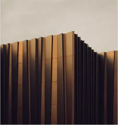 A shot of a modern building that appears to look like a book with a sun setting and casting shadow.