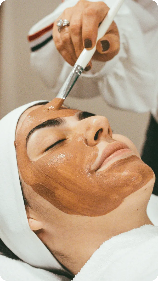 Image of a woman receiving a facial