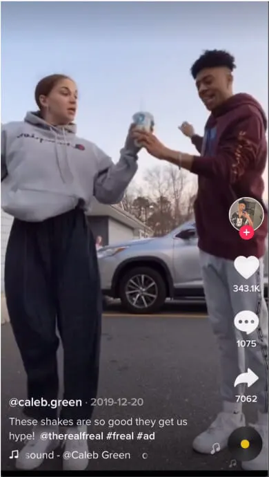 Still from a TikTok of two people sharing a freal milkshake