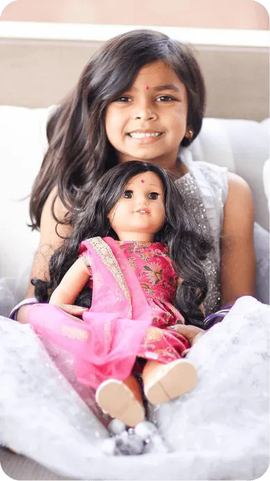 Ethnically diverse family influencers posing with their American Girl dolls