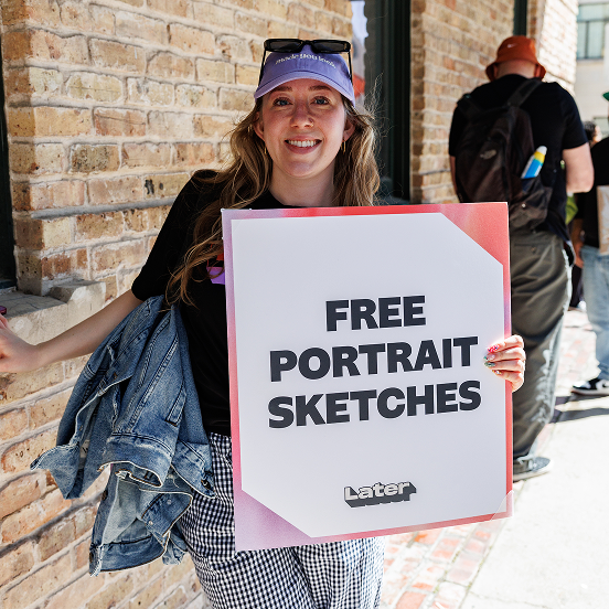 A 'Free portrait sketches' sign with the Later logo, held up on a city sidewalk.