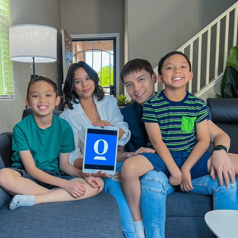 Creator sits on couch with partner and 2 sons while using OpenDoor on her tablet