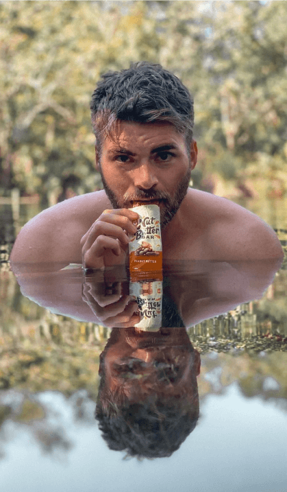 Campaign results next to image of a man eating a Clif Bar while swimming