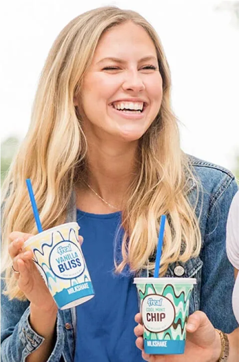 Woman laughs holding 2 freal milkshakes next to campaign results