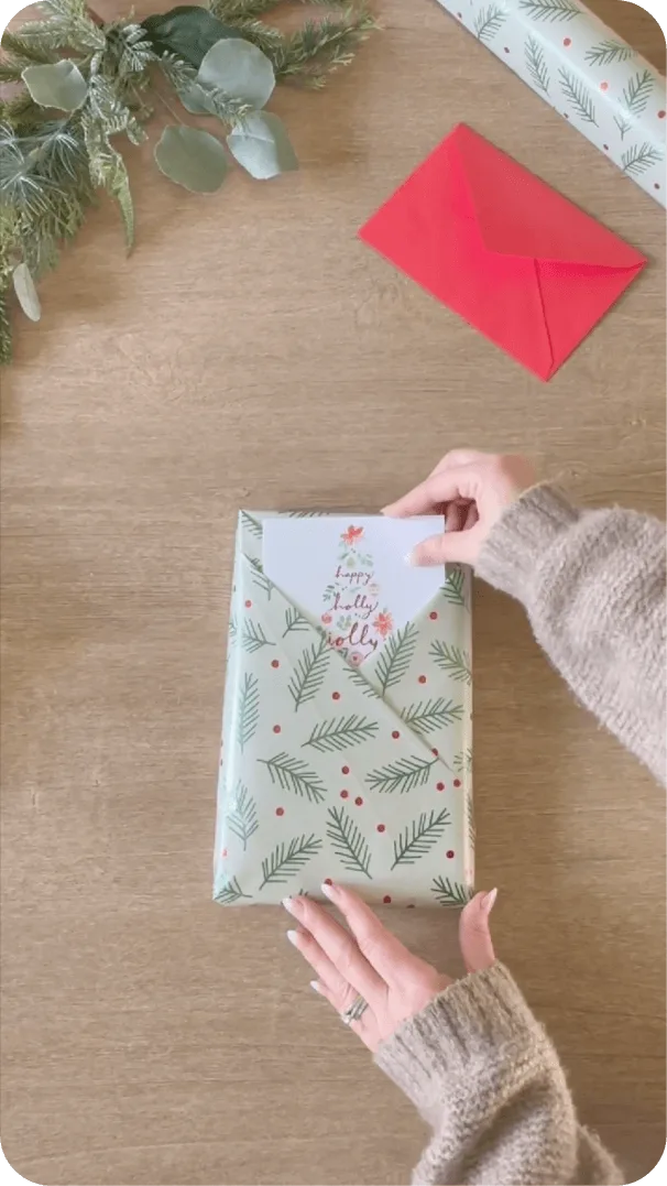 Instagram post with creator wrapping a Christmas gift with an American Greetings card