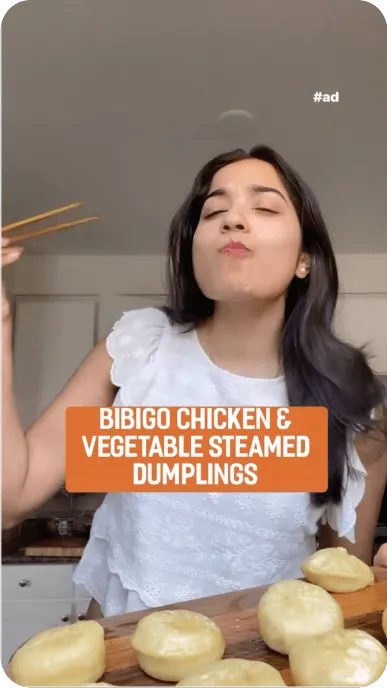 Creator is delighted to be eating bibigo chicken and vegetable steamed dumplings