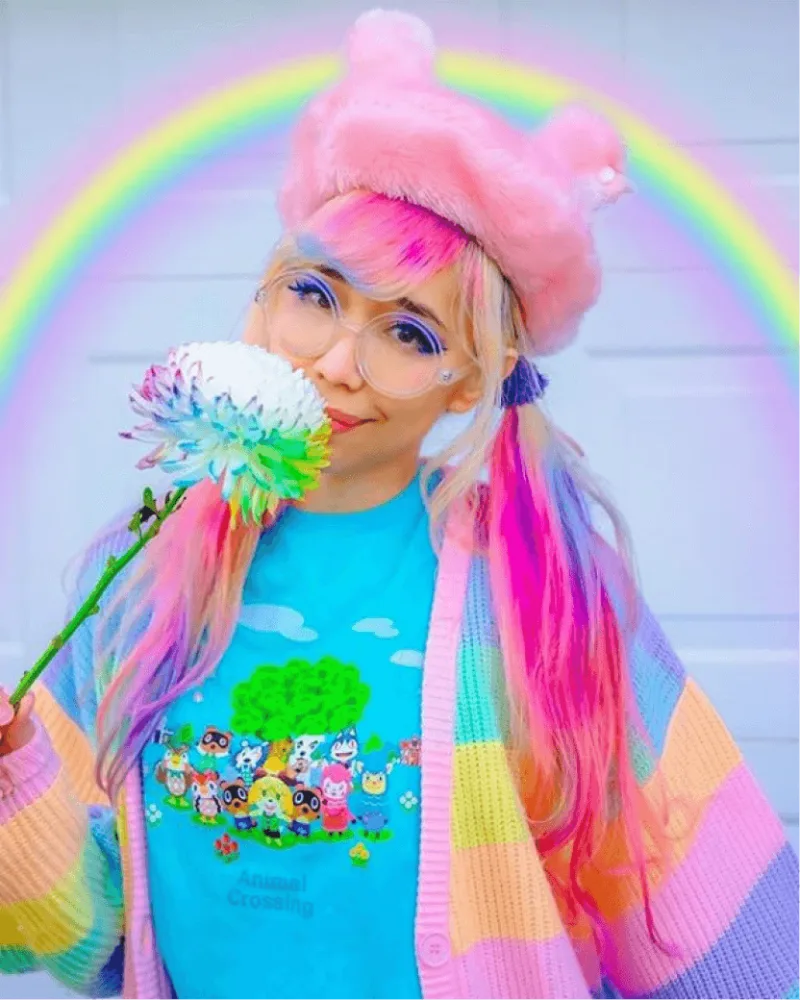 Creator with rainbow hair and animal crossing shirt posing next to key campaign stats