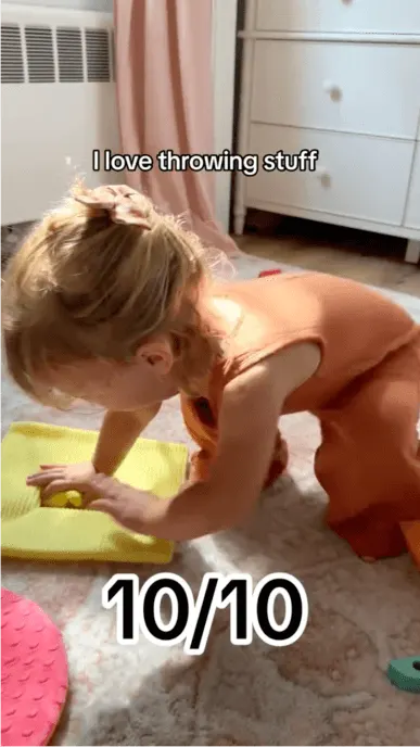 Still from social post with child playing with a toy on the floor from KiwiCo panda crate